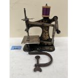 An early 20th century child's sewing machine. 4½' wide