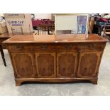 A yew veneered sideboard with three frieze drawers over four cupboard doors. 60' wide