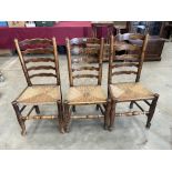 Three 19th century north country ladderback chairs with rush seats