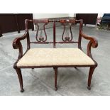 A mahogany double chair-back settee with lyre splats
