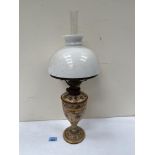 A ceramic based oillamp. 18½' high
