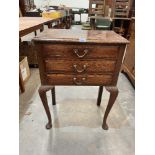 An oak side table with three drawers on cabriole legs. 22' wide