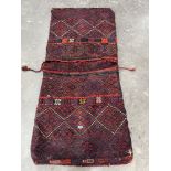 An eastern red ground saddle bag. 72' x 32'. Moth damaged