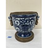 A Chinese blue and white decorated campana urn with bronze mounts. 9¾' high