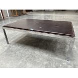 A leather topped and chrome based low table. 46' x 31'