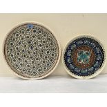 A middle eastern pottery glazed charger. 16' diam and another smaller example