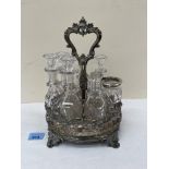 A 19th century plated cruet stand with seven associated glass bottles. 11' high