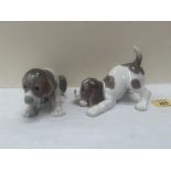 Two Lladro figures of puppies. 6' long