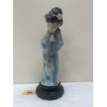 A Lladro polychrome painted figure of a Japanese lady. 10½' high