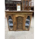 A beechwood cupboard enclosed by a carved panel door flanked by oval bevelled glass plates. 42'w x