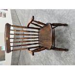 A Victorian ash and elm stickback elbow chair on splayed ring turned legs