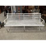 An early 20th century wrought iron and wood slatted garden seat. 72' long