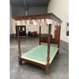 A 4'6' mahogany four-poster bedstead with foliate carved and reeded posts