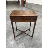 A George IV mahogany and rosewood crossbanded work table with frieze drawer over well slide (well