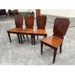 Holland & Sons. A set of four mahogany hall chairs on turned and sabre legs. Each stamped 'Holland &