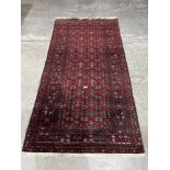 An eastern red ground rug. 90' x 45'