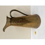 An Art-Nouveau repousse decorated brass conical ewer. 13½' high