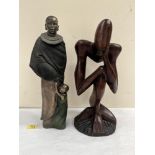 A carved wood sculpture 'The Thinker' 16' high and a cold cast resinous bronze group, Masai mother