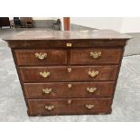 An 18th century walnut chest of two short over three long crossbanded drawers with reeded canted