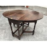 A James II joined oak dropleaf table raised on ring and bobbin turned legs. 36½' wide