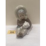 A Lladro figure of an Inuit child with polar bear cub