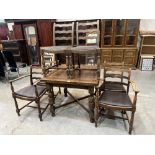 An oak drawleaf dining table and a set of six ladderback chairs