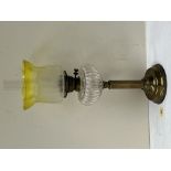 A Victorian brass oillamp with clear glass fount and green flashed etched shade. 24' high