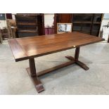 A refectory style dining table raised on baluster trestle support. 71' long x 36' wide