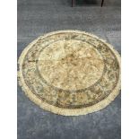 A gold ground circular rug. 78' diam.