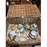A wicker hamper of eggshell china and plate
