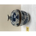 An oriental brass mounted jar and cover, decorated in blue and white on a cracalure glaze. 4¾' high