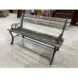 A cast iron and wood slatted garden seat. 48' long