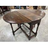 A joined oak dropleaf table raised on ring and bobbin turned legs. 36½' wide. Elements late 17th