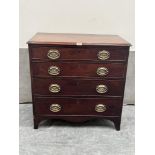 A George III mahogany chest of small size, with four long graduated drawers on slightly splayed