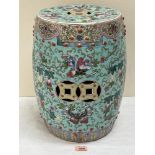 A Chinese barrel form garden seat, richly decorated with flying insects, trailing foliage and