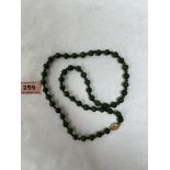 A necklace of jade beads. 23' long