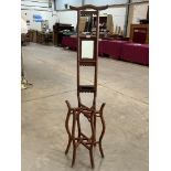 An Oriental bentwood shaving stand with integral mirror and 'official's hat' top rail. 64' high