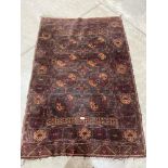 A tobacco ground Belouch rug. 62' x 43'