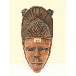 An African tribal carved mask. 14½' high