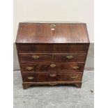 An 18th century and line inlaid writing bureau, the sloping fall enclosing a fitted interior over