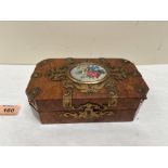 A 19th century walnut and brass applied manicure box, the lid with porcelain foliate painted