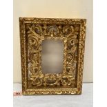 An Italian carved giltwood picture frame, the aperture 6' x 3¾'; 12' x 9¾' overall