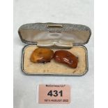 A pair of amber pebble cufflinks. 6g