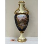 A Coalport inverted baluster vase, richly gilded and painted in enamels with a hilltop castle in