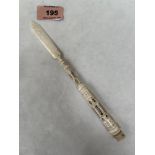 A Victorian carved bone letter opener/nib case with a stanhope to the terminal. 7¾' long