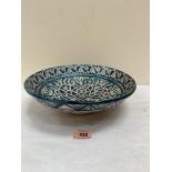An Iznik style glazed pottery bowl with geometric decoration. 11¼' diam.