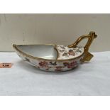 A continental sauce boat modelled as a boat, painted in enamels with flowering prunus and birds,