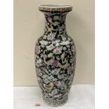 A Chinese famille-rose vase, painted with dragons and chrysanthemums on a black ground. 25' high.