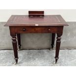 A George IV mahogany writing table, the leather inlet top with pen and ink well compartment, over