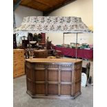 A panelled oak bar with canopy over. 62' wide